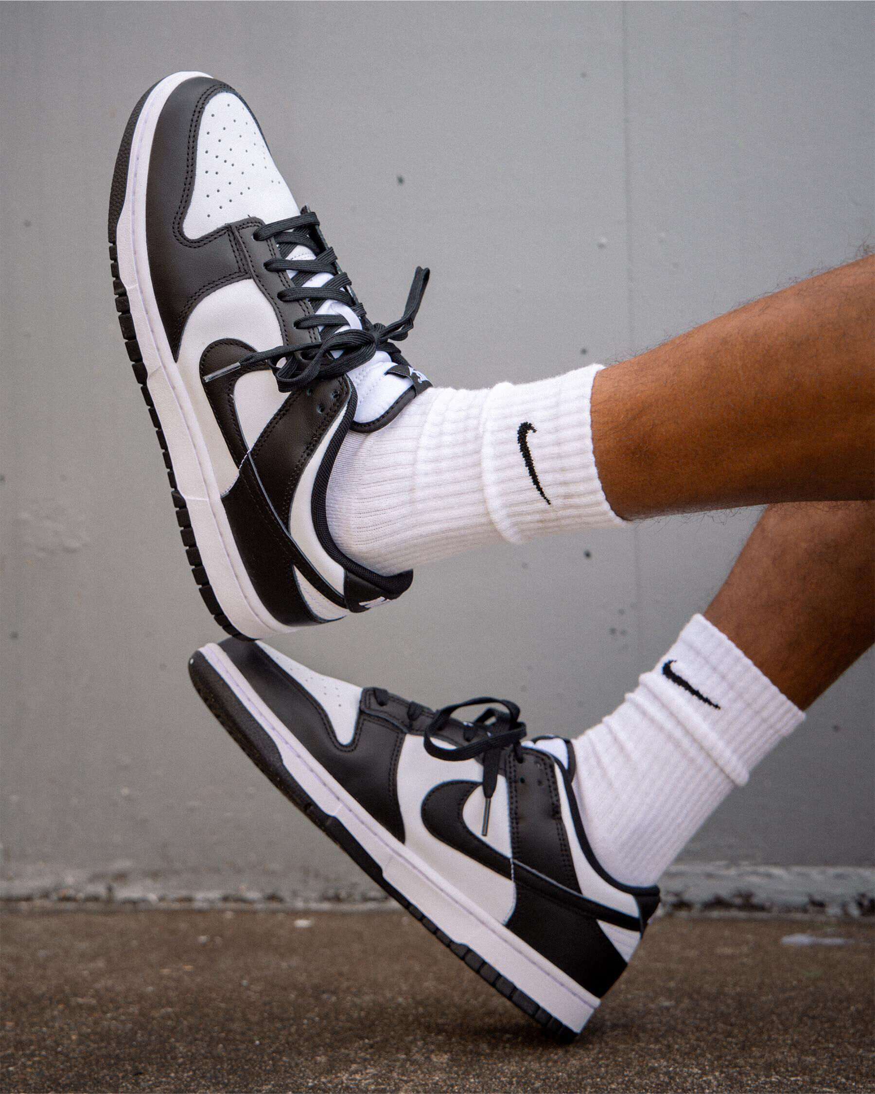 white black dunks on feet