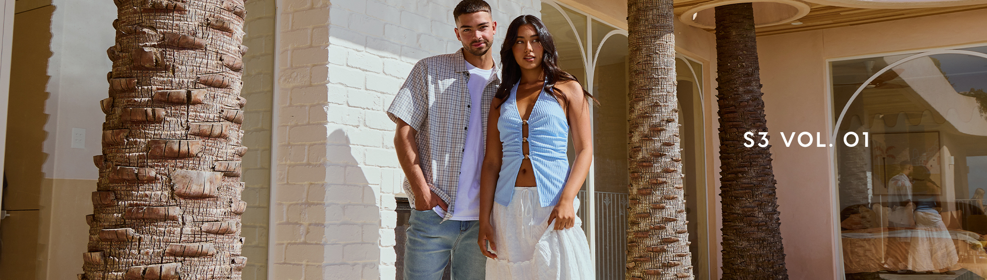 S3 Vol. 3 Lookbook. Image shows a woman and a man posing in a garden wearing City Beach fashion clothing