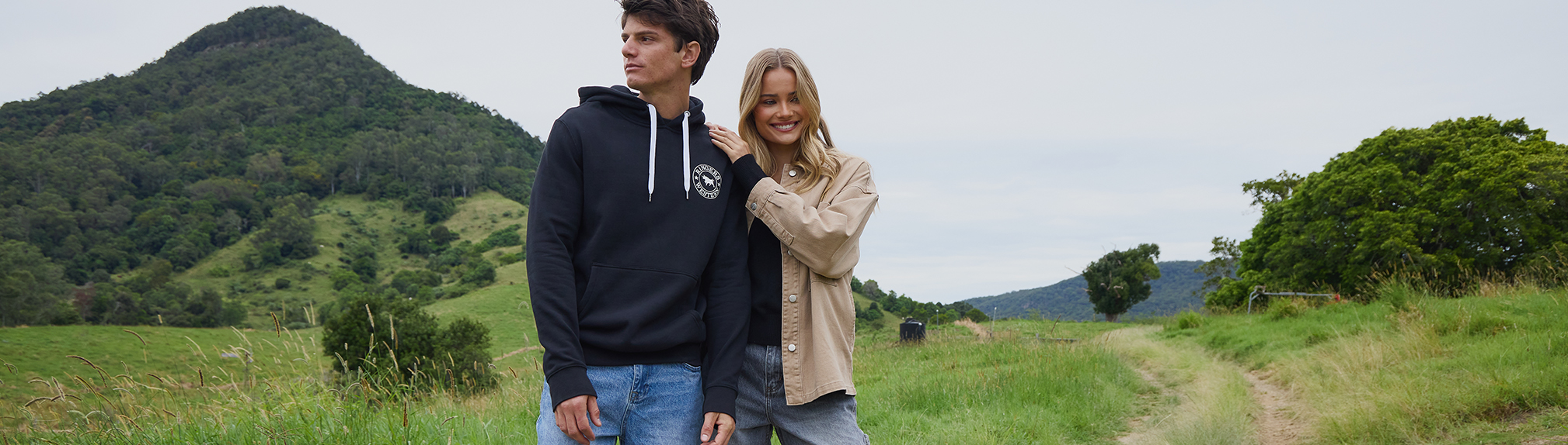 S4 Vol. 1 Lookbook. Image shows a woman and a man posing in a garden wearing City Beach fashion clothing