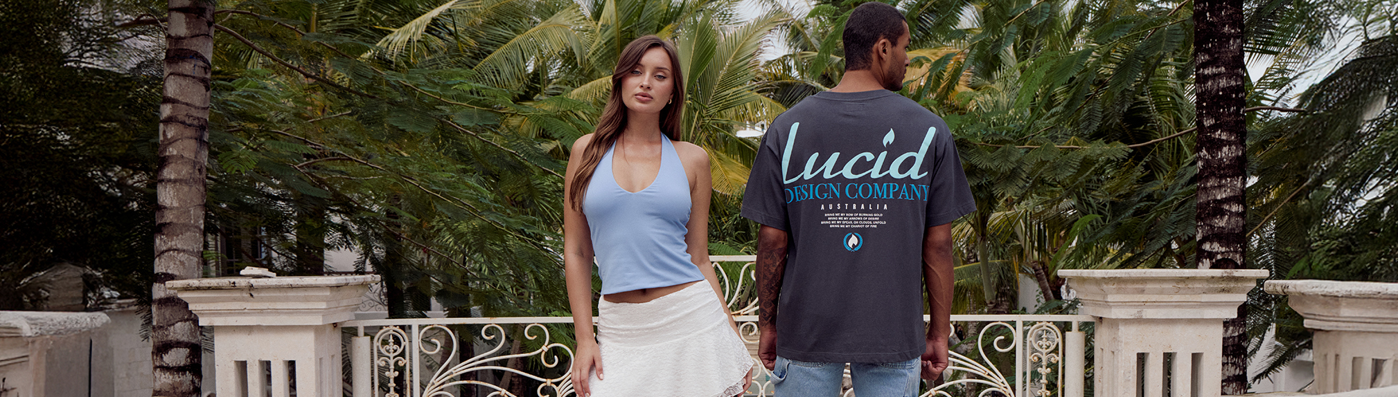 S4 Vol. 1 Lookbook. Image shows a woman and a man posing in a garden wearing City Beach fashion clothing