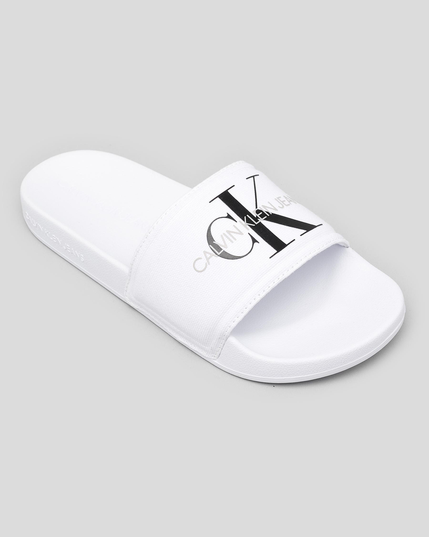 Shop Calvin Klein Monogram Slide Sandals In Bright White - Fast ...