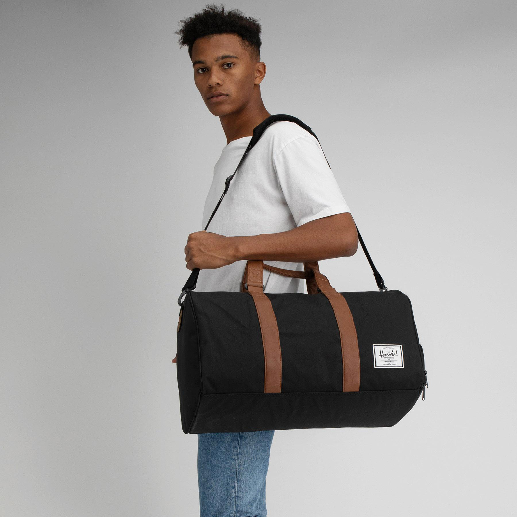 Shop Herschel Novel Duffle Bag In Black/tan Fast Shipping & Easy